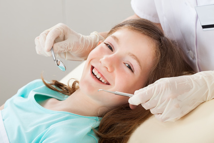 happy girl undergoing dental treatment at clinic